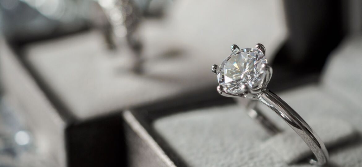 Image of luxury Diamond ring in jewelry gift box with bokeh light background